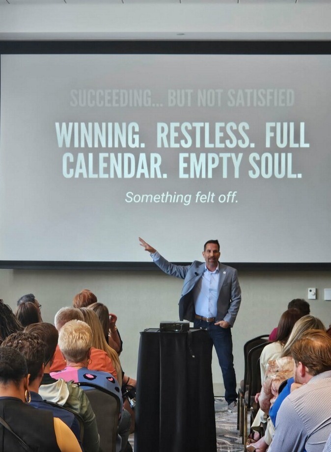 Kevin presenting a message about success and satisfaction to an audience